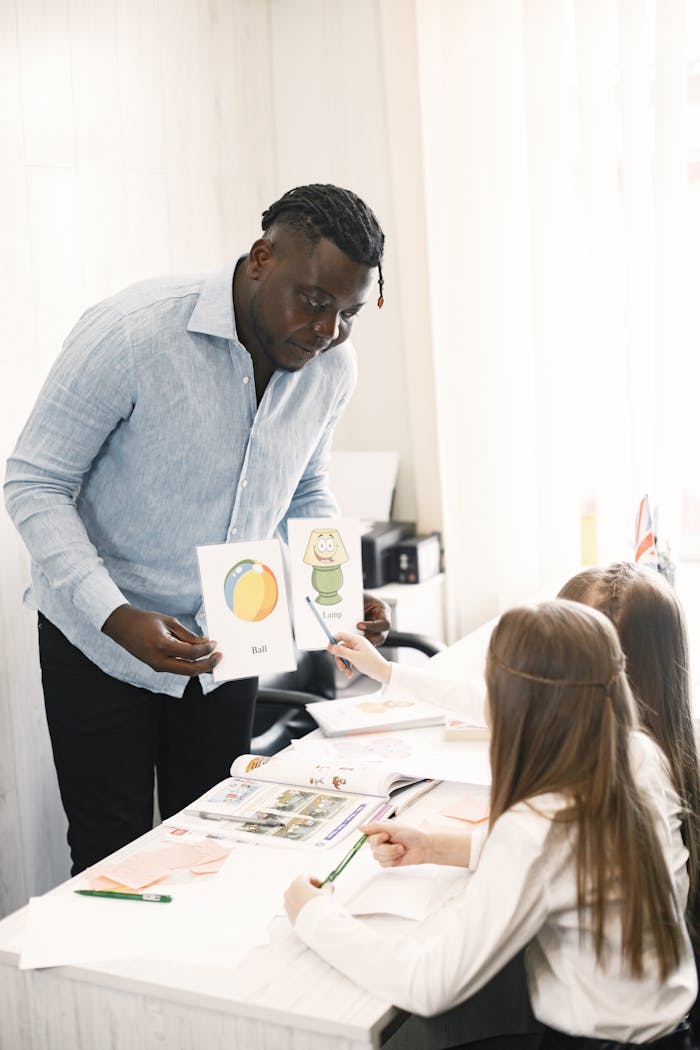 African American teacher interacting with students during an educational session indoors.