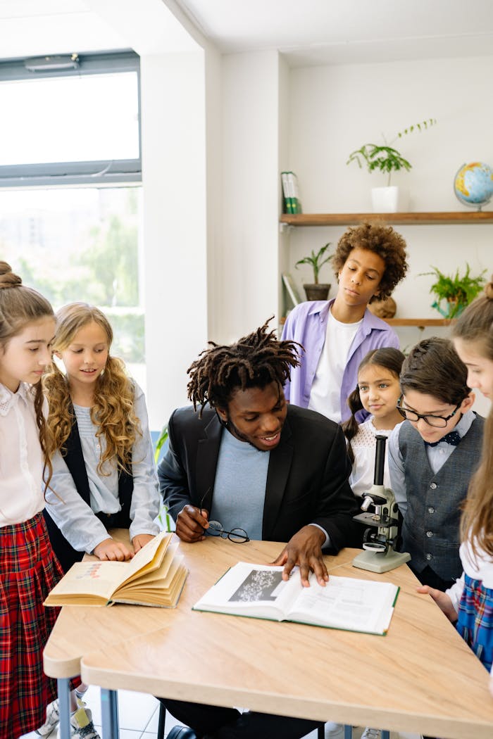A diverse group of students learning with a teacher in a bright classroom setting.